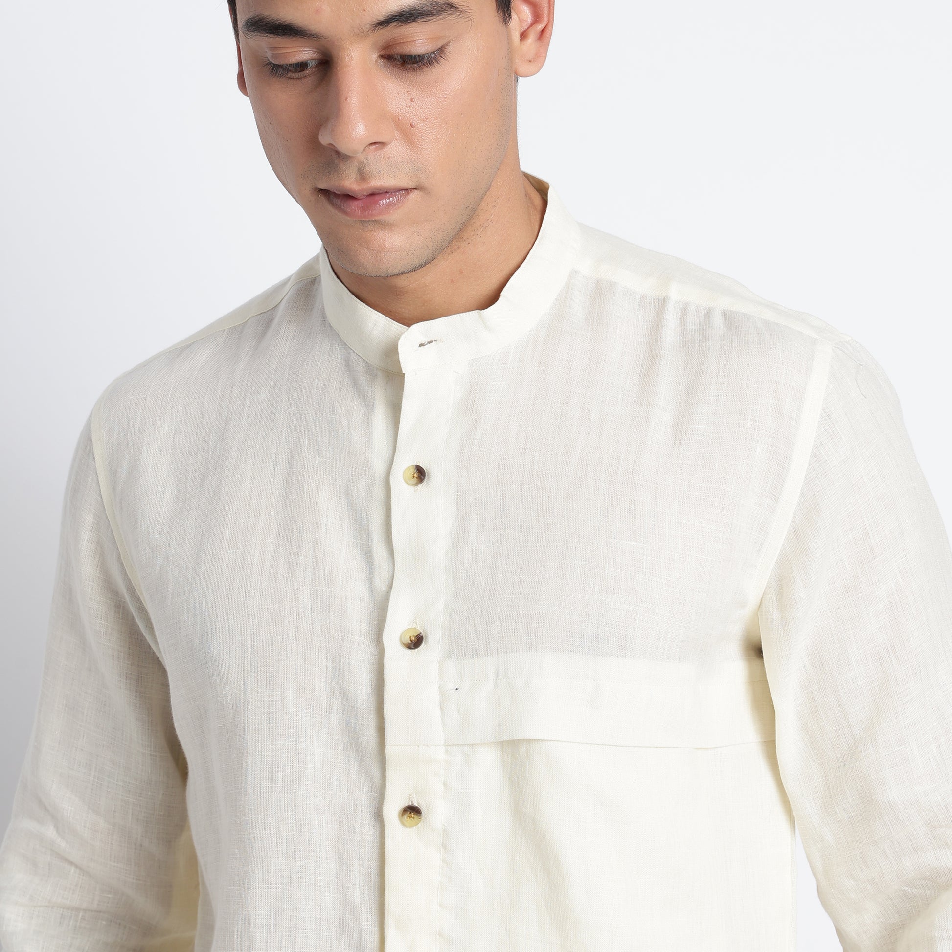 Linen shirt in butter featuring a concealed placket and stand-up band collar
